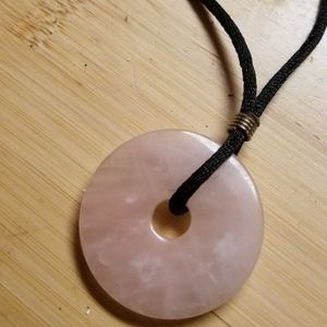 Vintage Rose Quartz Pi Stone necklace on black leather cord.
